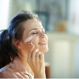 rose quartz facial roller woman